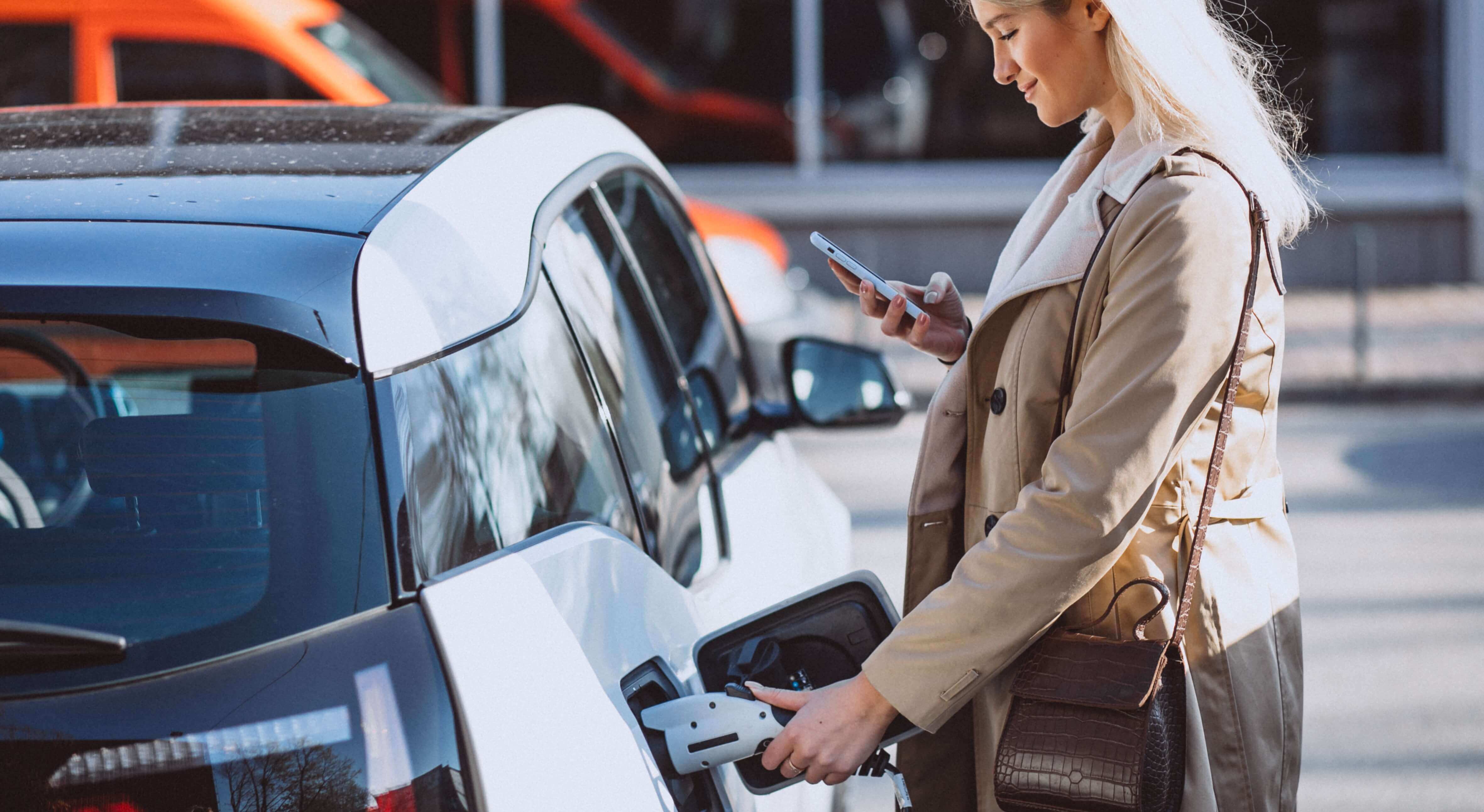 Woman Charging Electro Car Electric Gas Station (Cropped)